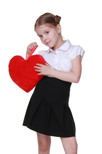 Caucasian schoolgirl with red heart symbol - Foto, Bild