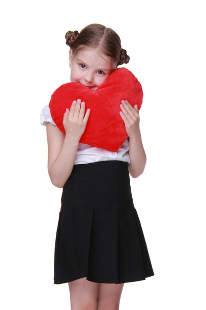 Caucasian schoolgirl with red heart symbol - Foto, imagen