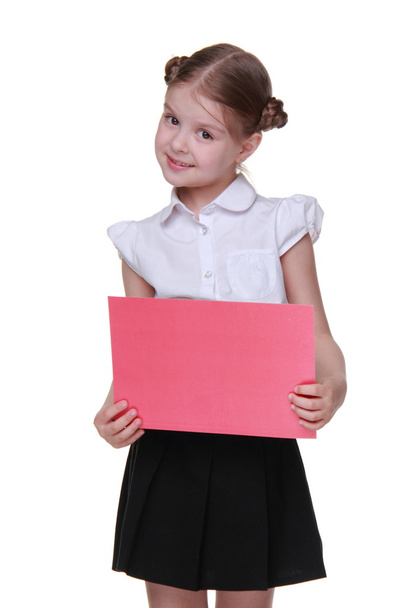 Happy schoolgirl with a sheet of paper - Фото, изображение