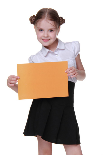 Happy schoolgirl with a sheet of paper - Photo, Image