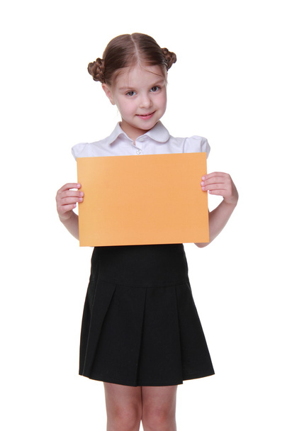 Happy schoolgirl with a sheet of paper - Foto, afbeelding