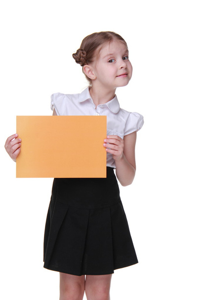 Happy schoolgirl with a sheet of paper - Фото, зображення