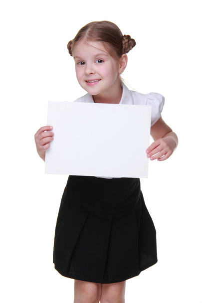 Happy schoolgirl with a sheet of paper - Fotografie, Obrázek