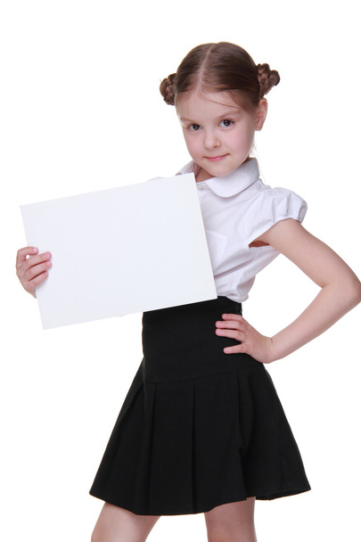 Happy schoolgirl with a sheet of paper - Foto, imagen