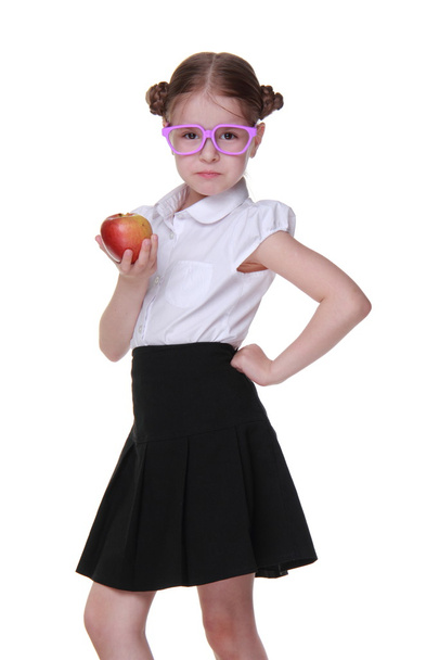 Portrait of a schoolgirl in glasses holding an apple - Foto, Imagen