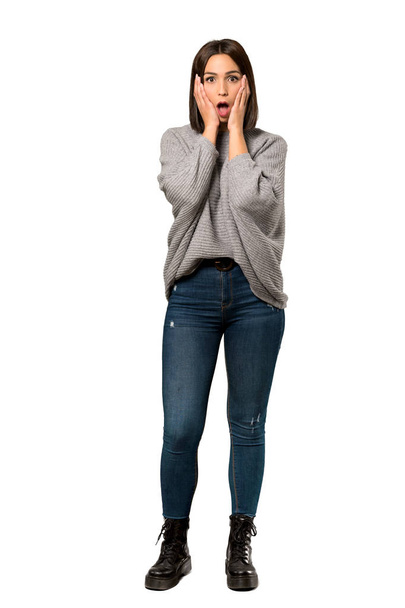 A full-length shot of a Young woman surprised and shocked while looking right over isolated white background - Photo, image