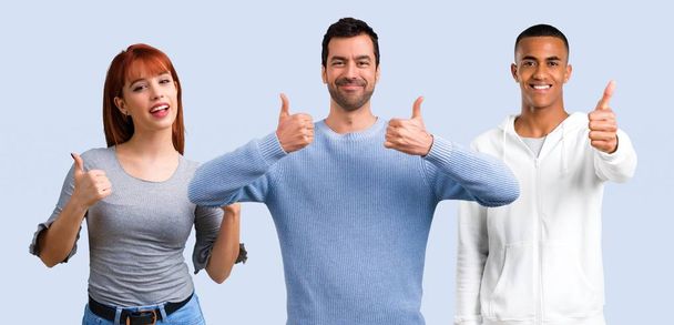 Group of three friends giving a thumbs up gesture and smiling - Photo, Image