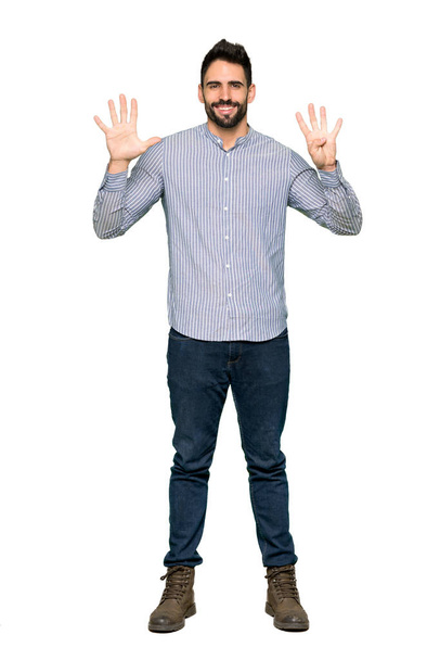 Full-length shot of Elegant man with shirt counting nine with fingers on isolated white background - 写真・画像