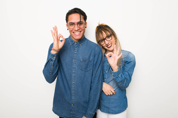 Giovane coppia con occhiali che mostra un segno ok con le dita
 - Foto, immagini