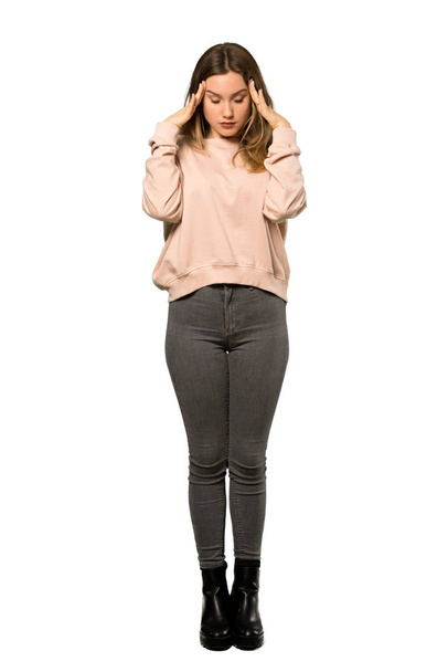 A full-length shot of a Teenager girl with pink sweater with headache over isolated white background - Foto, Imagem