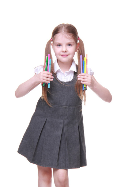 Studio portrait of schoolgirl with felt-tip pens - Photo, image