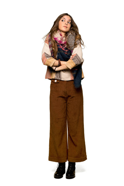 Full-length shot of Young hippie woman making doubts gesture while lifting the shoulders on isolated white background - Foto, Bild