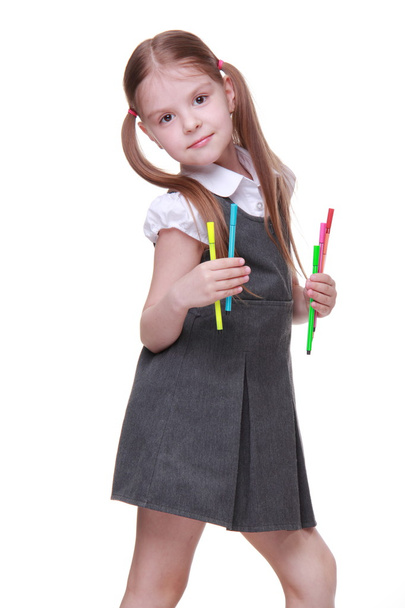 Studio portrait of schoolgirl with felt-tip pens - Foto, imagen