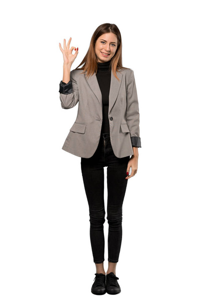 A full-length shot of a Business woman showing ok sign with fingers over isolated white background - 写真・画像