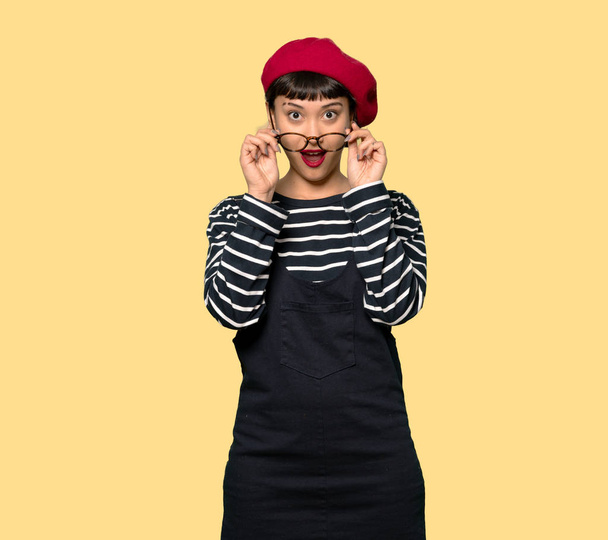 Young woman with beret with glasses and surprised - Photo, Image