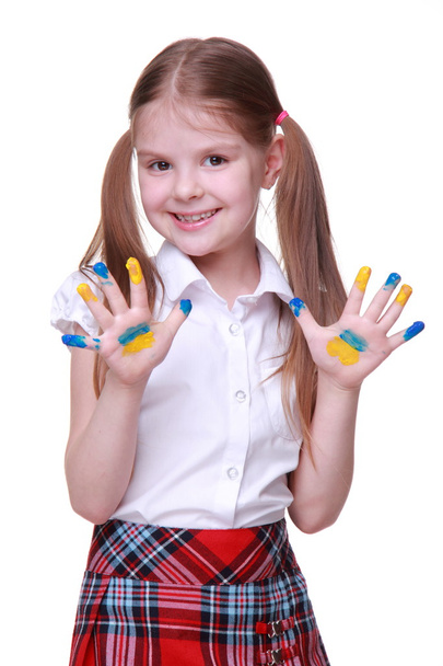 Happy little girl with hands painted as ukrainian flag - Foto, Imagen