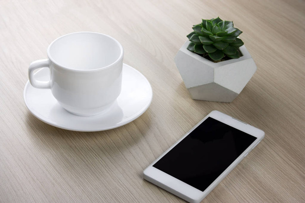 coffee cup, succulent and smartphone  on a wooden table - Foto, immagini