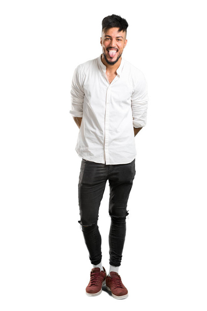 A full-length shot of a Arabic young man with white shirt makes funny and crazy face emotion on isolated white background - Fotografie, Obrázek