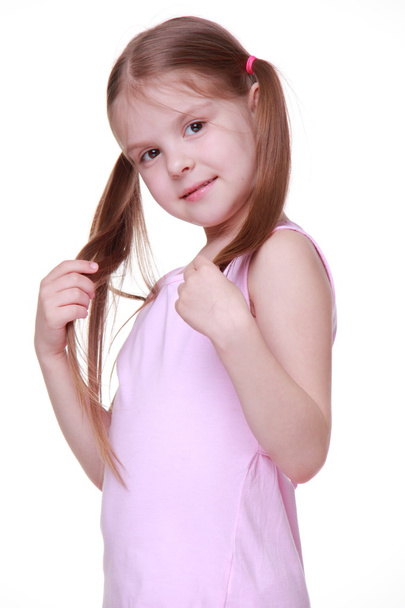 Studio portrait of little girl in pink dress - Photo, Image