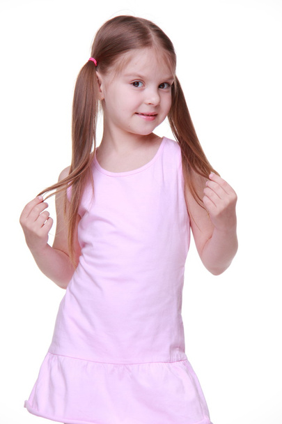 Studio portrait of little girl in pink dress - Фото, изображение