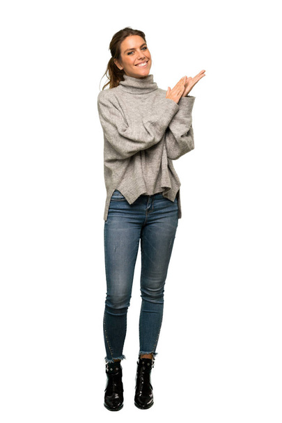 A full-length shot of a Blonde woman with turtleneck applauding after presentation in a conference over isolated white background - Foto, Imagem