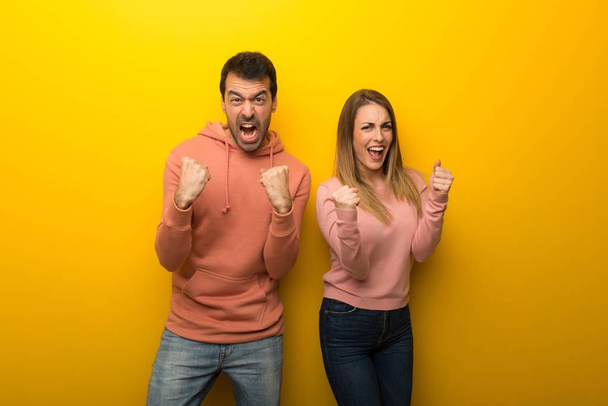 Group of two people on yellow background frustrated by a bad situation - Photo, Image