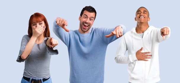 Group of three friends pointing with finger at someone and laughing a lot - Photo, Image