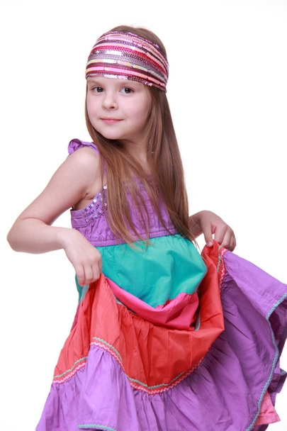 Little girl in a colorful dress posing in studio - Фото, зображення