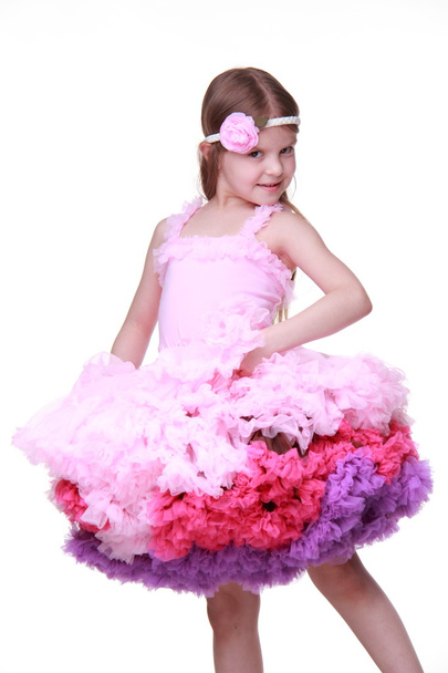 Little girl in a pink dress dancing isolated on a white background - Photo, image