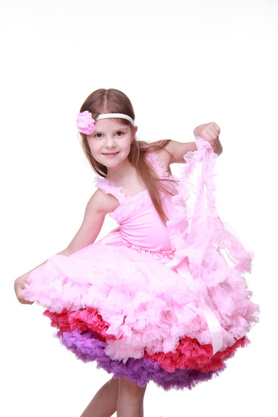 Little girl in a pink dress dancing isolated on a white background - Fotoğraf, Görsel