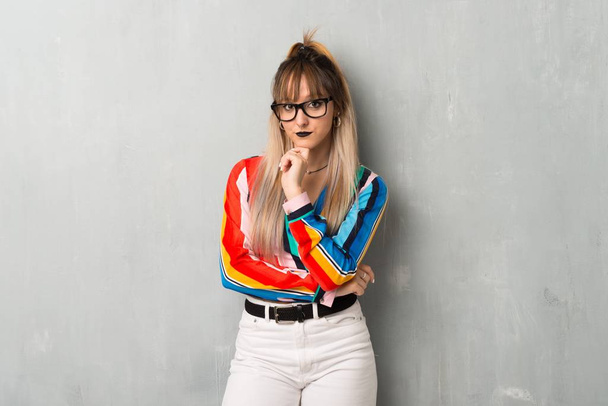 Young  girl with colorful clothes with glasses and smiling - Photo, Image