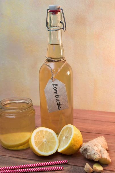 Vintage bottle and jar with Kombucha tea with lemon and ginger - Фото, изображение