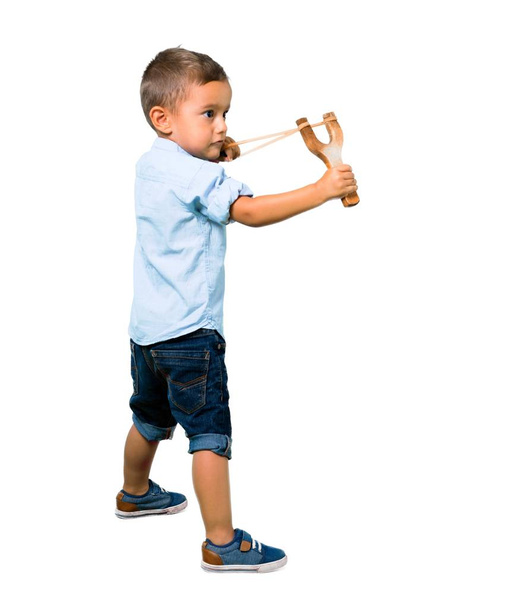Little kid with slingshot on isolated white background - 写真・画像