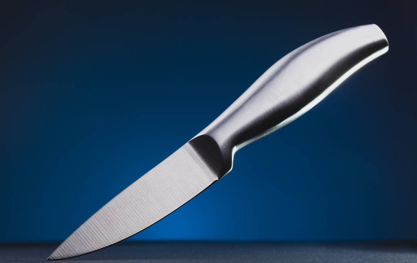 steel kitchen knife on the blue background - Φωτογραφία, εικόνα