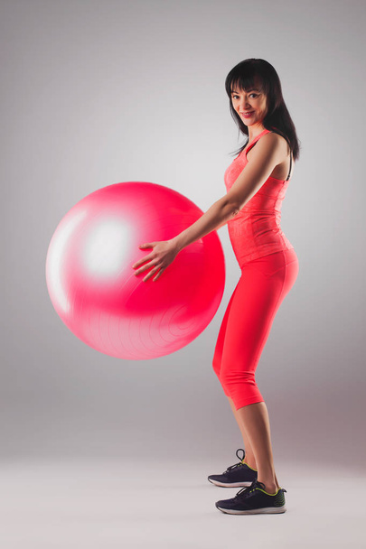 cute brunette woman doing exercises with fitball. Studio photography - Fotografie, Obrázek