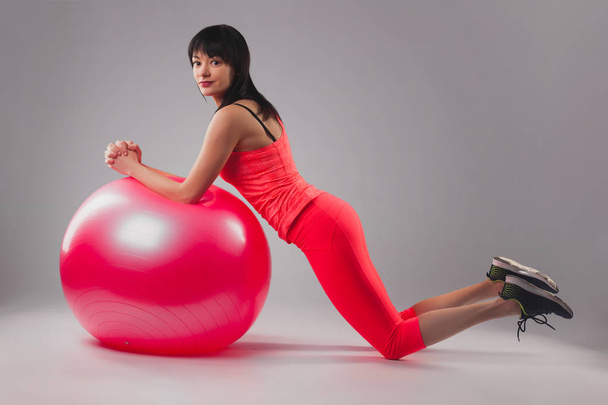 cute brunette woman doing exercises with fitball. Studio photography - Photo, Image