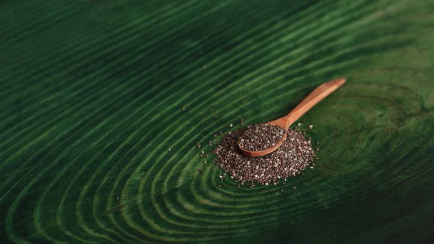 Healthy food Chia seeds in a wooden spoon. Organic vegetarian food closeup. - Photo, Image