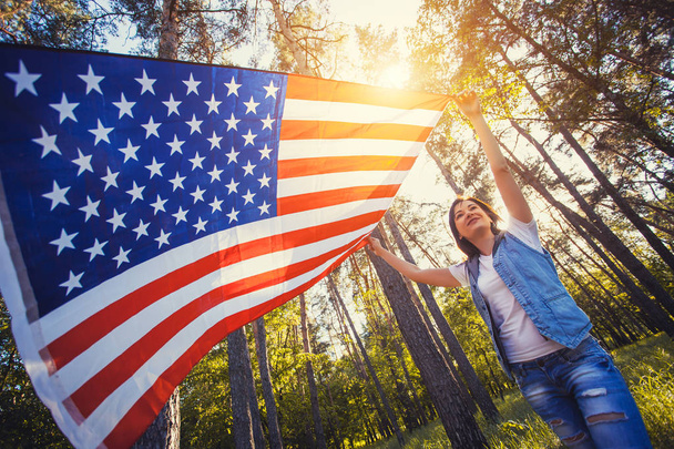 happy smiling young woman with national american flag outdoors. Independence Day, 4th July - Photo, image
