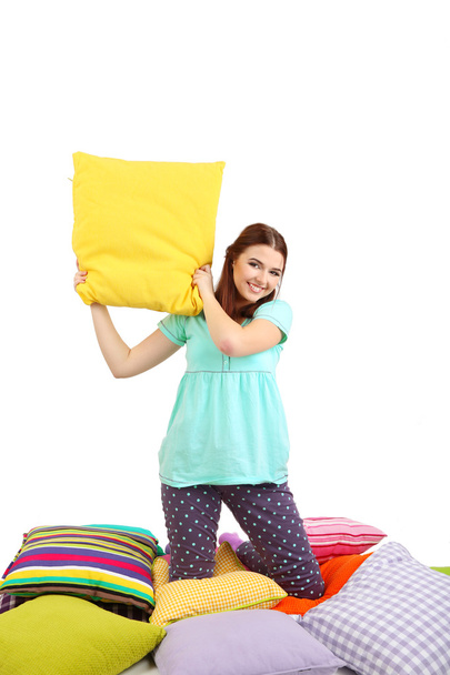 Beautiful young girl with pillows isolated on whit - Foto, afbeelding
