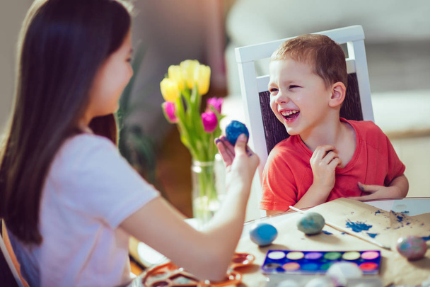 Children painted Easter eggs at the table - Photo, Image