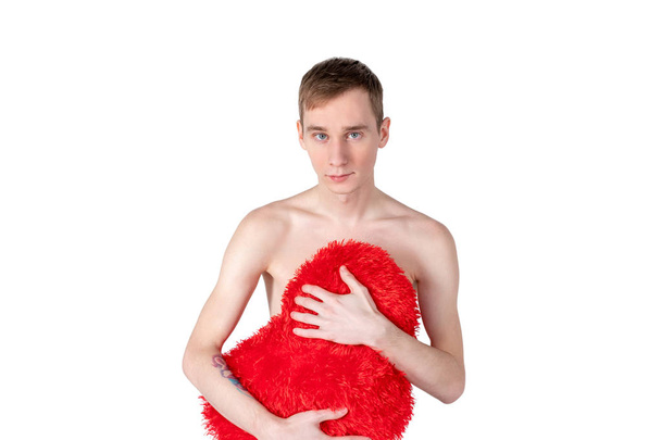 Handsome guy hold big red heart on white background. Love and romantic concept. - 写真・画像