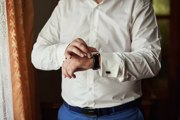 businessman checking time on his wrist watch, man putting clock on hand,groom getting ready in the morning before wedding ceremony. Men Fashion - Fotó, kép