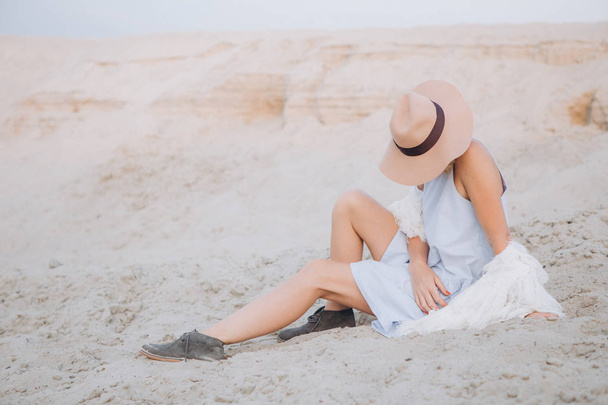 girl in a hat solitude in the desert with sand outside sunny - Valokuva, kuva