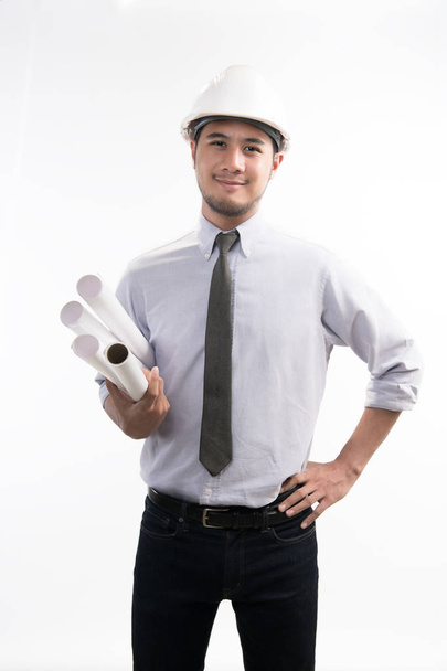 Портрет азиатского инженера или архитектора, держащего чертеж улыбающегося и смотрящего на камеру изолированного на белом фоне
 - Фото, изображение