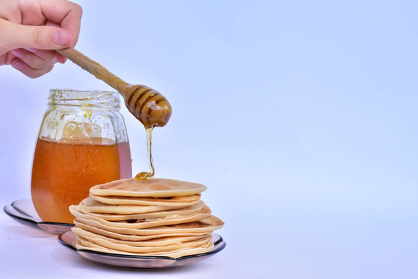 pancakes with honey on blue background  - Photo, Image