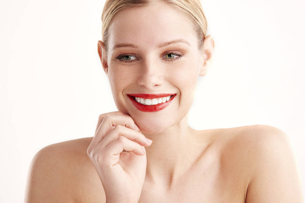 Close-up portrait of beautiful young woman with red lipstick and blond hair looking away while posing at isolated white background. - Φωτογραφία, εικόνα