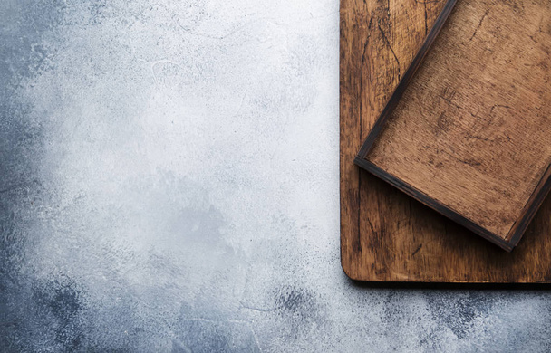Food cooking background. Gray kitchen table, wooden cutting board and tray. Place for text, horizontal image, view from above. - Fotó, kép