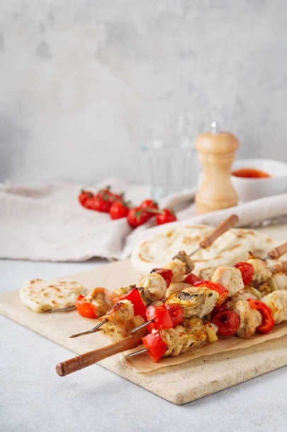Turkey or chicken shish kebab on skewers with mushrooms and fresh pitas. Mediterranean food concept. - Photo, Image