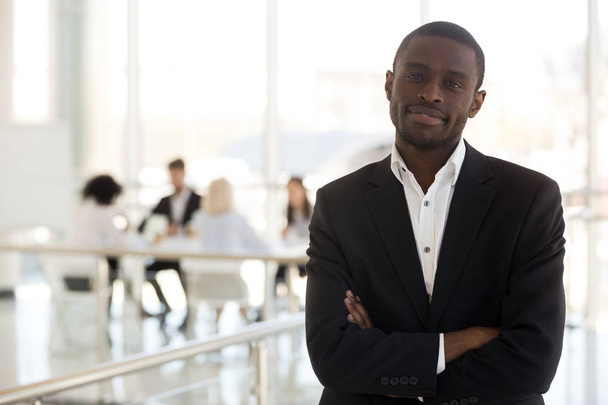 Black businessman standing in office with hands crossed on chest - Photo, image