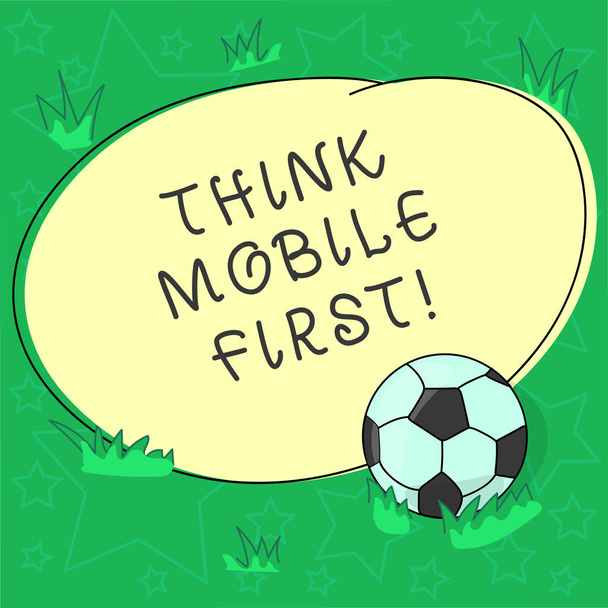 Texto de escritura a mano Think Mobile First. Concepto que significa el diseño de la experiencia en línea para los teléfonos antes de la bola de fútbol web en la hierba y en blanco Delineado de color redondo Forma foto
. - Foto, Imagen